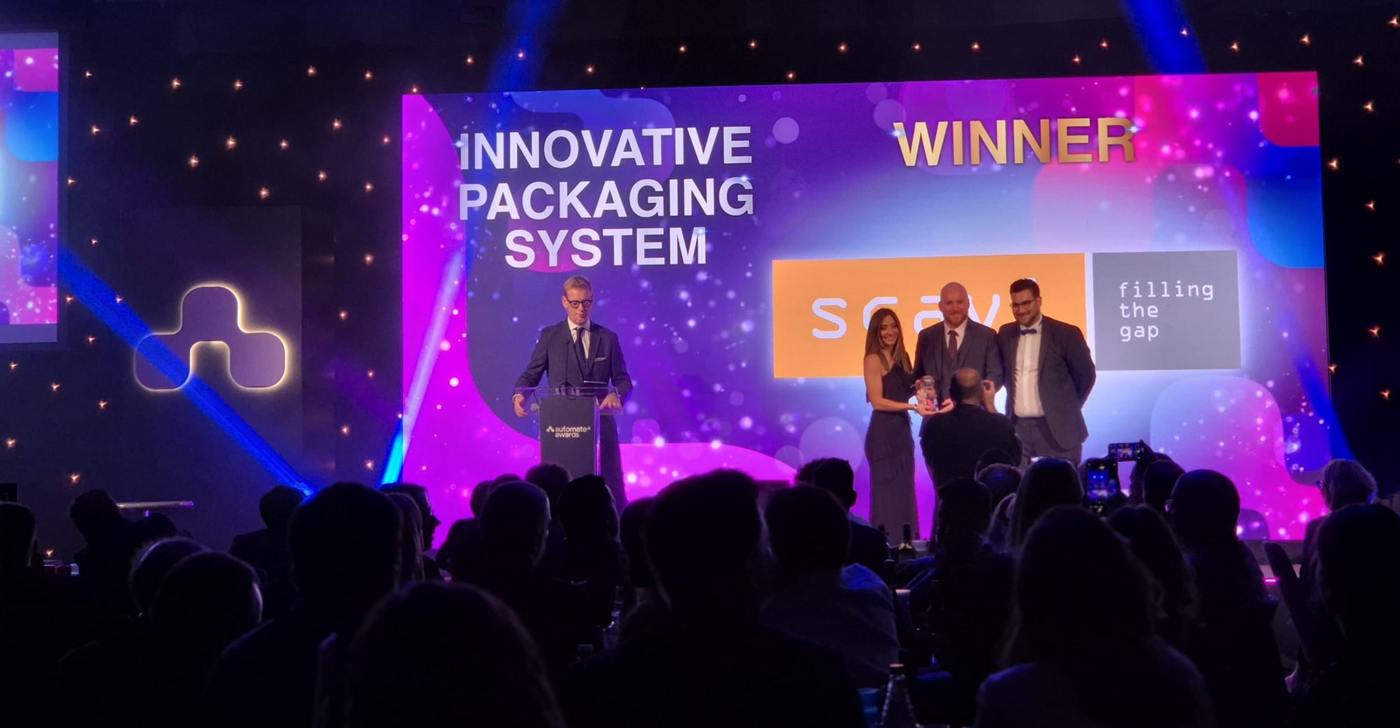 Award ceremony with 'Innovative Packaging System' winner on a large screen